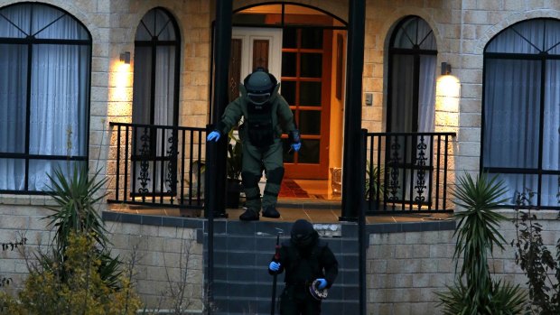 Bomb squad officers at the Melbourne property on Friday night.