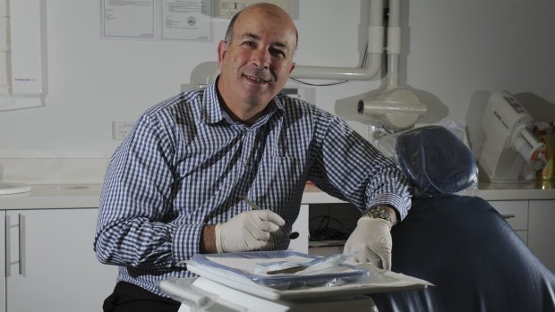 Dental surgeon Dr. Carmelo Bonanno at his Woden surgery. The surplus of dentists has been noticed far and wide.