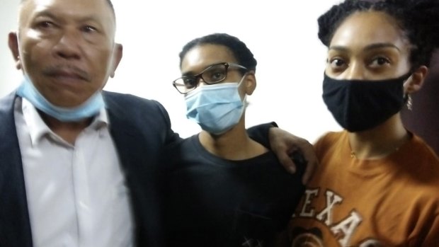 American graphic designer Kristen Antoinette Gray, center, her partner Saundra Michelle Alexander, right, and lawyer Erwin Siregar arrive at the local immigration office for questioning, in Denpasar.