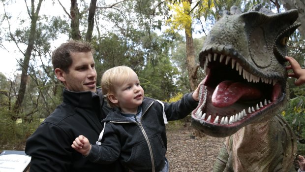 Tim McGrath and son Arthur, 1, of Weston get up close and personal with Australovenator during National Science Week.   