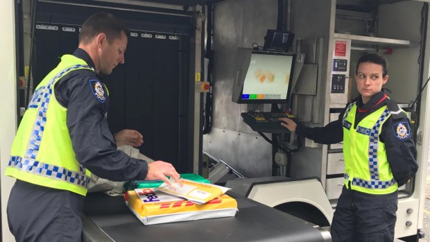First Class Constable Katie Roberts scans parcels through the new x-ray truck. 