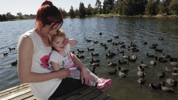 Jessie Graham and daughter, Sienna Shepherd, 2, feed the ducks at Yerrabi Pond.