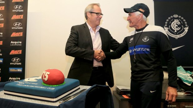 Mick Malthouse is presented with a cake ahead of his record-breaking 715th game as coach.