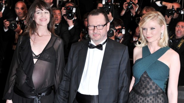 Von Trier at the 2011 Cannes Film Festival with Melancholia stars Charlotte Gainsbourg and Kirsten Dunst.