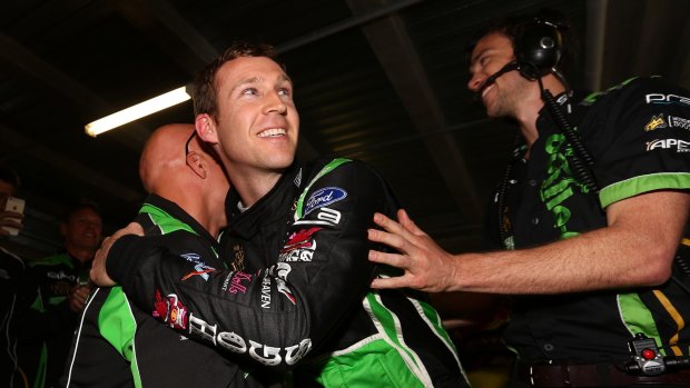 David Reynolds celebrates with co-driver Dean Canto after taking pole position for the Bathurst 1000.