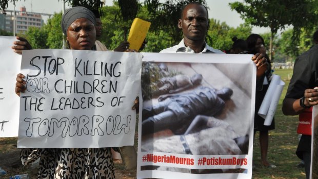 The death continues: A group protests an earlier tragedy, when a bomber killed 27 students inside school grounds in Potiskum, Nigeria.