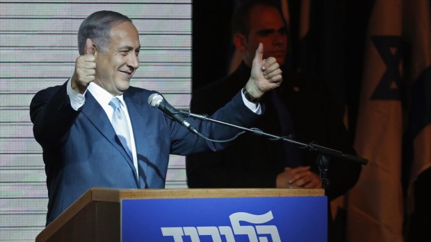 Benjamin Netanyahu gestures to supporters at party headquarters in Tel Aviv. 