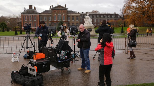 A TV crew sets up outside Kensington Palace ahead of the announcement of Prince Harry's engagement.