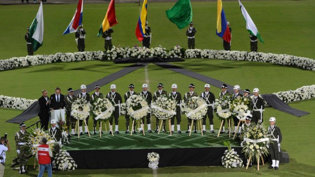Soldiers and police attend a tribute to members of Brazil's Chapecoense soccer team who died in the crash.