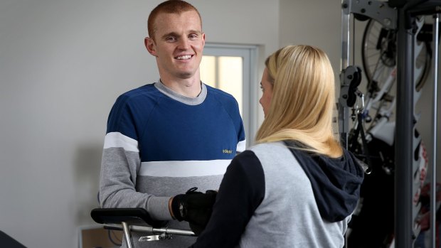 Anger is gone: Knights physio Pip Cave helps Alex McKinnon with his rehab.