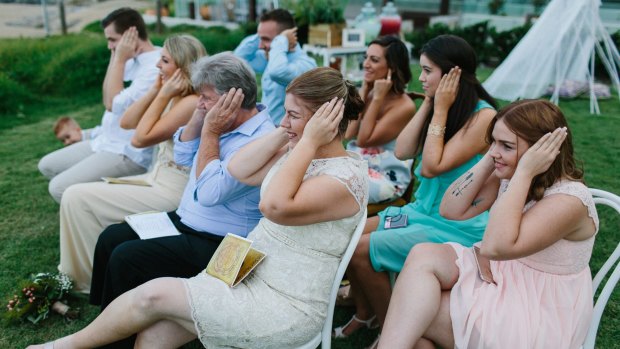 Not just between a man and a woman: Friends and family join in the protest at the Johnstons' wedding.