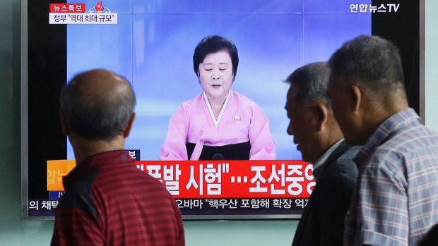Seoul commuters watch a North Korean newscaster's announcement on Pyongyang's fifth atomic test. 