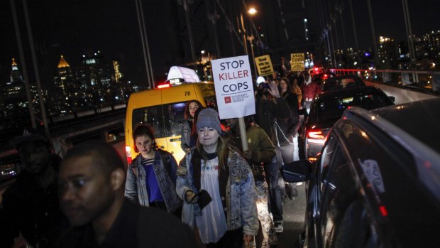 Demonstrators block traffic along Manhattan Bridge during a protest march in New York. 