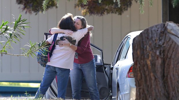 Two women embrace outside Rancho Tehama Elementary School, where a gunman opened fire but didn't kill anyone due to the school being in lockdown. 