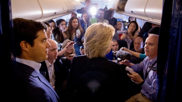 Democratic presidential candidate Hillary Clinton speaks to members of the media on board her campaign plane as she travels to Florida on September 6.