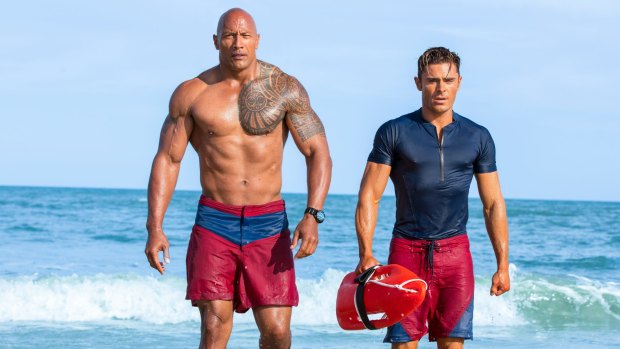 Buff daddy: Dwayne Johnson and Zac Efron in the movie reboot of  Baywatch. 