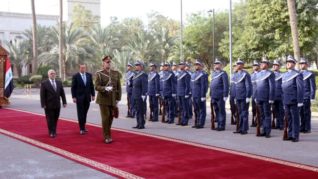 Iraqi Prime Minister Haider al-Abadi and Australian PM Tony Abbott walking on the red carpet during a welcoming ceremony in Baghdad. 