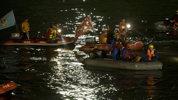 Rescuers search the river through the night. 