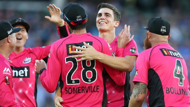 Sixers players celebrate with star bowler Sean Abbott.