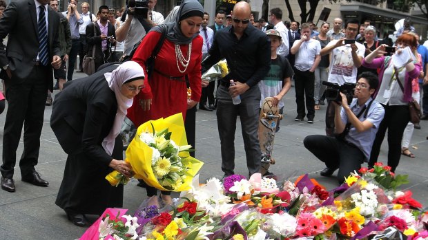 All together: Members of the Muslim community lay flowers at Martin Place.