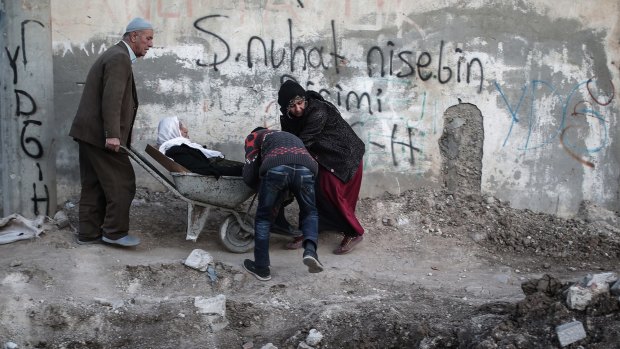 A sick person is carried through barricades set up by the Kurdistan Workers' Party in Nusaybin, in southeastern Turkey, on Christmas Eve. 