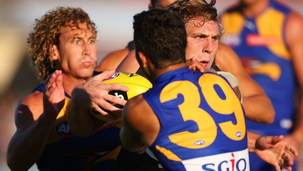 Tom Bell of the Blues is tackled by Matt Priddis and Malcolm Karpany of the Eagles.