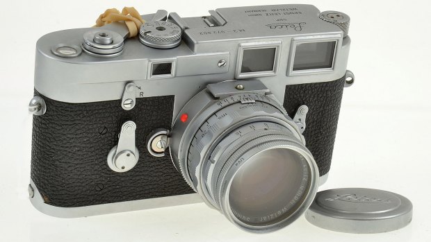 A Leica M3 (1959) with Summicron lens (1958), lens cap, UV filter and ER case. Estimates $1200 to $1600.
