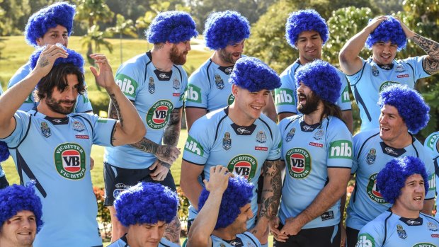 True Blue: James Tamou, left, and his teammates try on their novelty wigs at the team photo in Coffs Harbour on Wednesday.