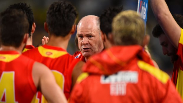 Trouble in paradise: Coach Rodney Eade with Gold Coast players.