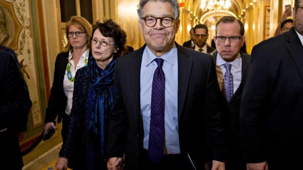 Senator Al Franken, flanked by his wife Franni Bryson, arrives in the US Capitol to announce his resignation. 
