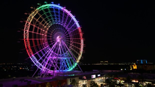 The Orlando Eye observation wheel lights up in rainbow colors Sunday night.