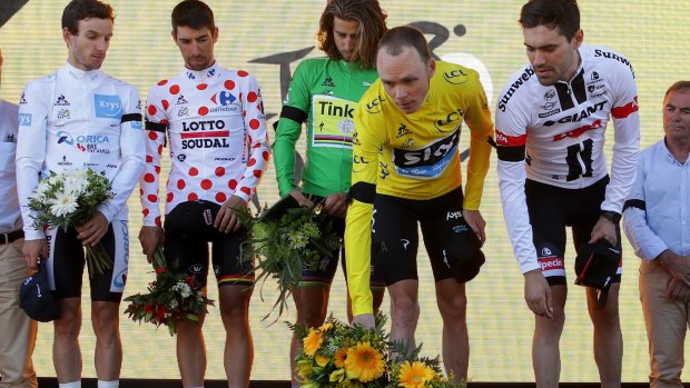 Tour de France leader Chris Froome, in yellow, and stage winner Tom Dumoulin lay flowers in tribute to the victims of the Nice truck attack. 