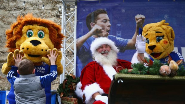 Santa Claus, and Chelsea mascots Stamford the Lion and Bridget the lioness welcome fans outside the stadium prior to the match between Chelsea and Sunderland on Saturday.