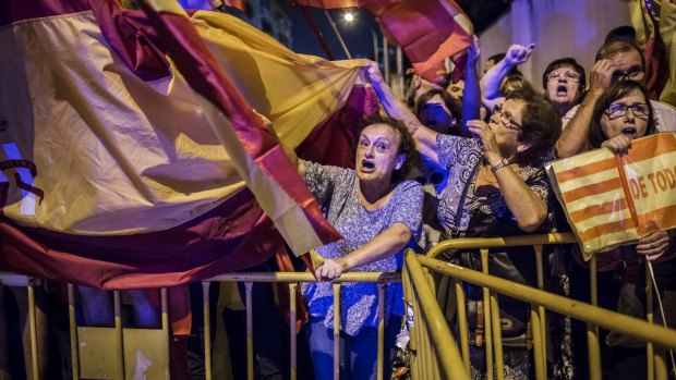 Anti-separatist demonstrators fight back as some of the region's largest companies shift their head offices elsewhere due to instability.