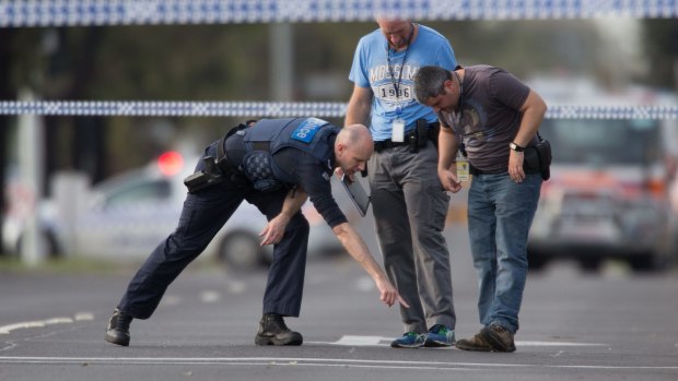 Detectives check the scene where a patrol car came under fire in Hoppers Crossing. 