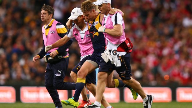Sam Mitchell leaves the field after hurting his ankle against Sydney.