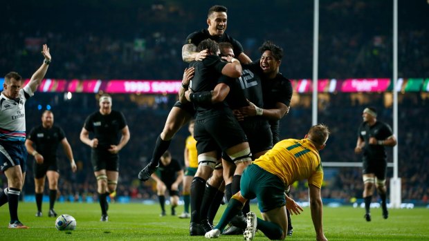 Celebration: Sonny Bill Williams jumps on the huddle after Ma'a Nonu scores New Zealand's second try.