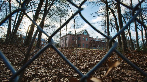 A fence encloses a now-closed Russian compound in the village of Upper Brookville on Long Island. 