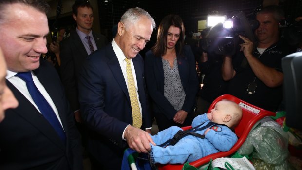 Prime Minister Malcolm Turnbull meets four-month-old Ezekiel during election campaigning.