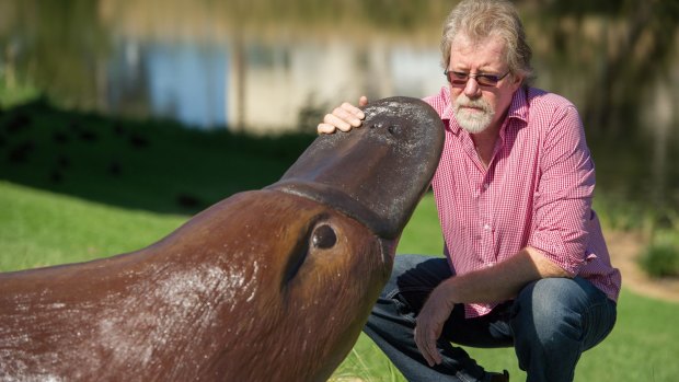 Artist Neil Dickinson on the banks of the Queanbeyan River, with the city's latest public artwork 'Queany' the platypus.