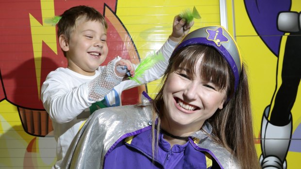 Harry Irvine, 7, of Macgregor with Captain Neon clowning around at the Centenary Hospital for Women and Children. 