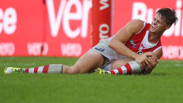 The incident: Swans ruckman Callum Sinclair grimaces after suffering a knee injury. 