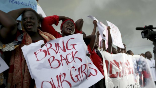 Women react during a protest demanding security forces search harder for the schoolgirls abducted by Boko Haram.