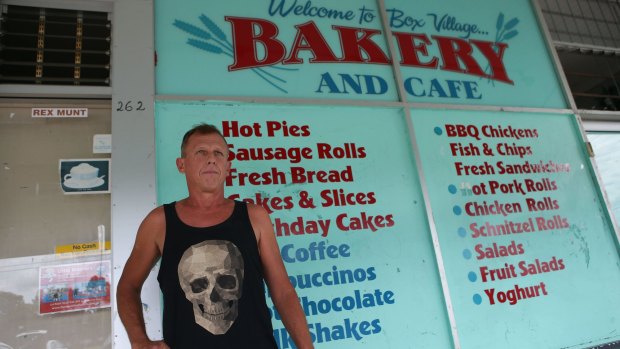 Ross Paull, standing outside the Box Village Bakery and Cafe, said his family became ill.