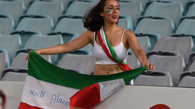 Marriage proposal: "Will Alireza marry me" is written on to the Iranian flag by a supporter during Iran's match against Qatar in Sydney.