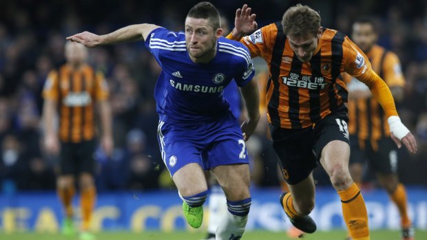 On the run: Chelsea's Gary Cahill takes the ball away from Hull's Nikica Jelavic at Stamford Bridge.