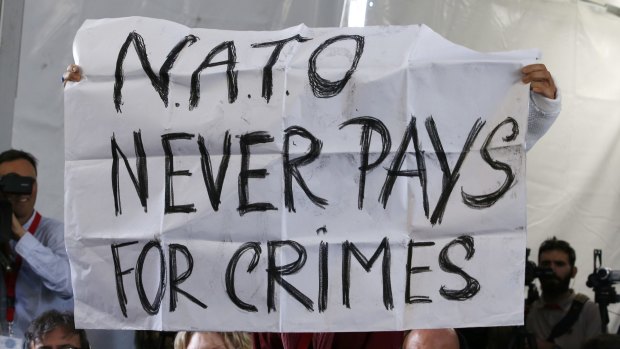 Banners belonging to anti-war campaigners in Trapani, Italy on Monday at the opening of Operation Trident Juncture, NATO's largest military exercise in 13 years.