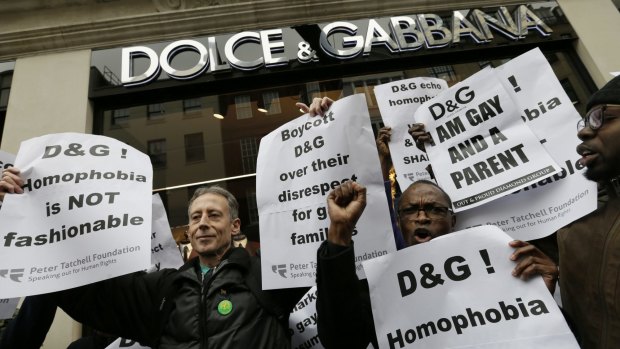 Campaigner Peter Tatchell, left, holds a banner during a demonstration held by The Out and Proud Diamond Group and the Peter Tatchell Foundation, outside the Dolce & Gabbana store in London.