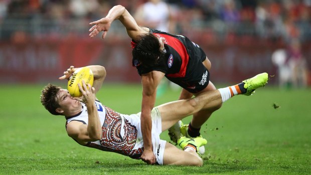 GWS' Toby Greene takes a mark despite the efforts of Essendon's Mark Baguley.