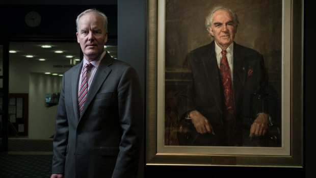 Michael McGarvie, Victorian Legal Services Commissioner, with a portrait of his late father Richard McGarvie who as a judge in 1984 heavily criticised the governance of the Supreme Court of Victoria. 